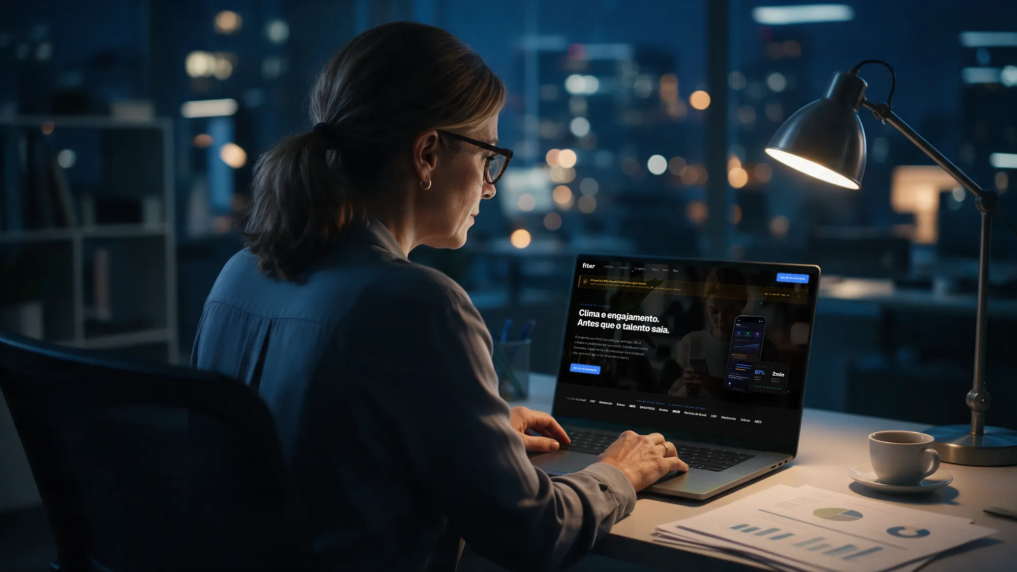 An HR director at night with the Fiter HR page open on her laptop
