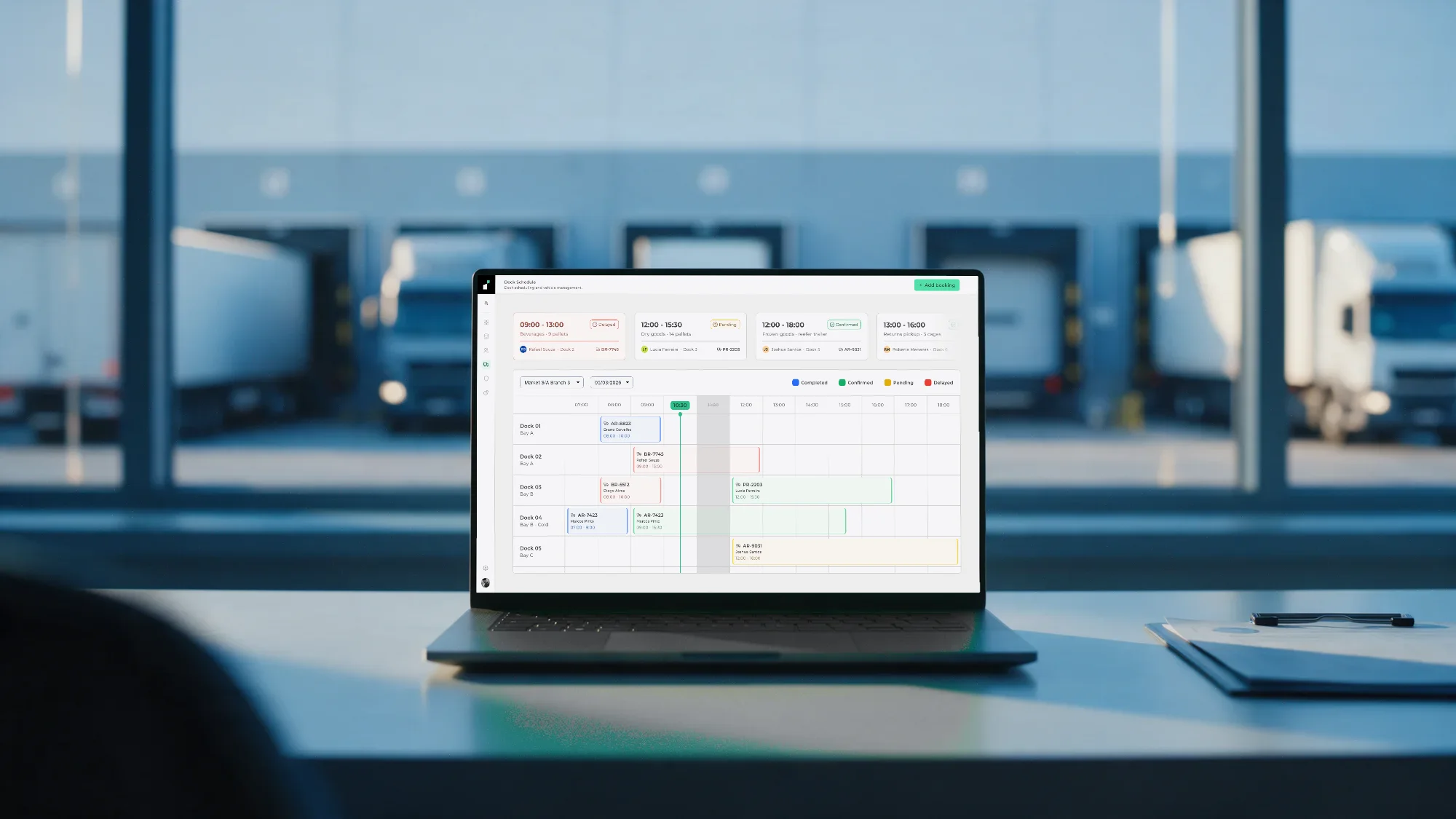 The Instivo dock schedule open on a laptop in a warehouse office overlooking loading docks